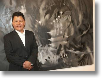 CARLOS JACANAMIJOY WITH ONE OF HIS MONOCHROMATIC PAINTINGS